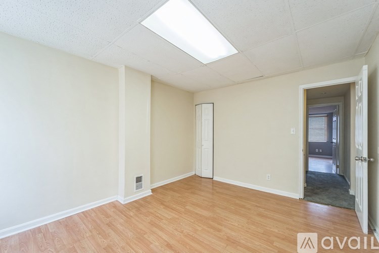 A room with wooden floors and a skylight.