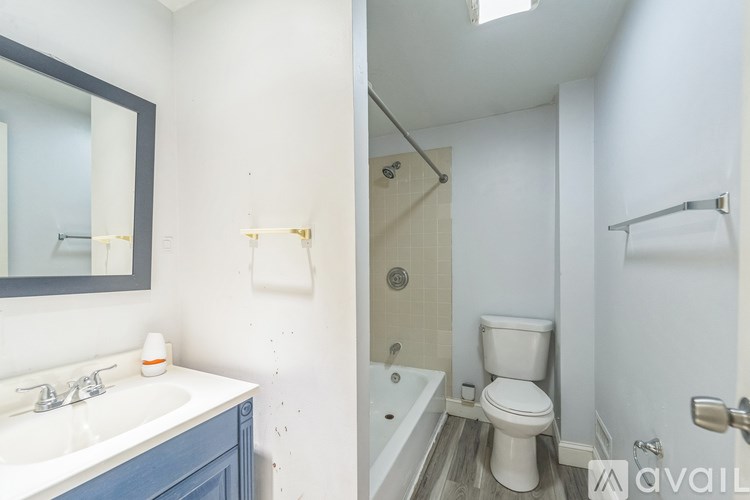 A bathroom with a white sink and a white toilet.