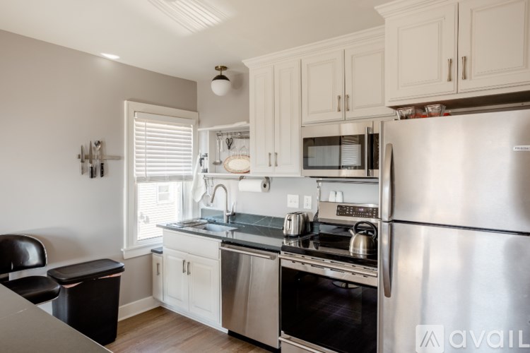 A kitchen with a stainless steel refrigerator, oven, and microwave.