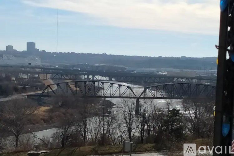 A bridge over a river with a city in the background.