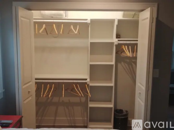 A white closet with shelves and hangers.