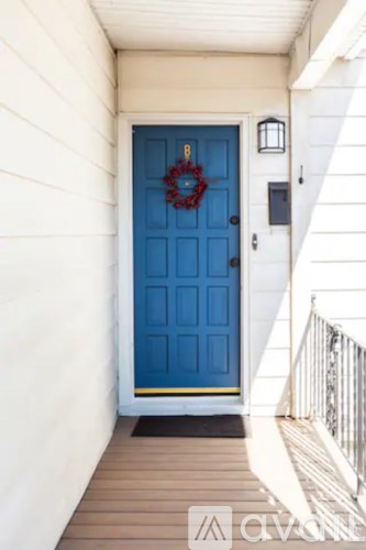 A blue door with a wreath on it.