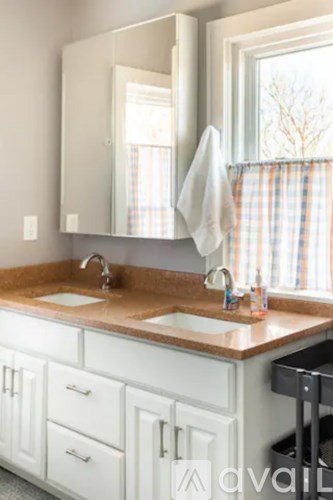 A bathroom with a sink and a mirror.