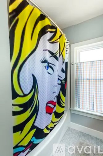 A woman's face is painted on a wall.