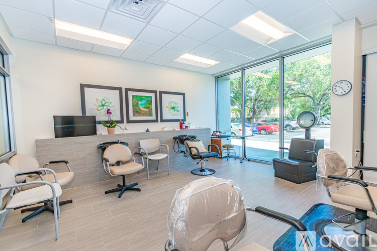 A waiting room with chairs and a television.