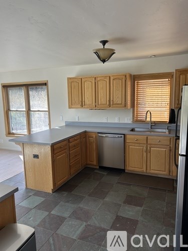 A kitchen with wooden cabinets and a checkered floor.