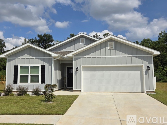 A two-story house with a garage is available for purchase.