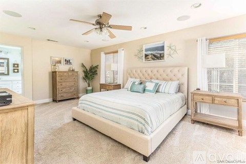 A bedroom with a large bed, a dresser, and a nightstand.