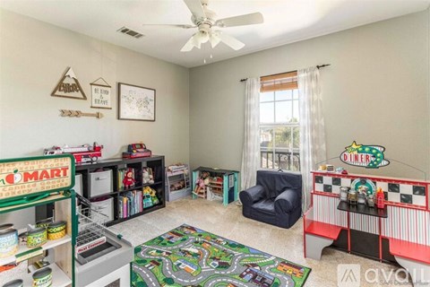 A child's playroom with a diner playset and a toy car race track.