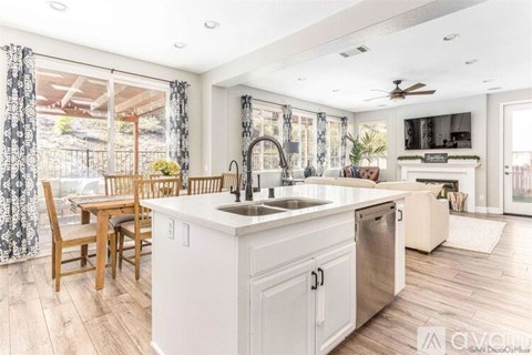 A modern kitchen with a wooden table and chairs.