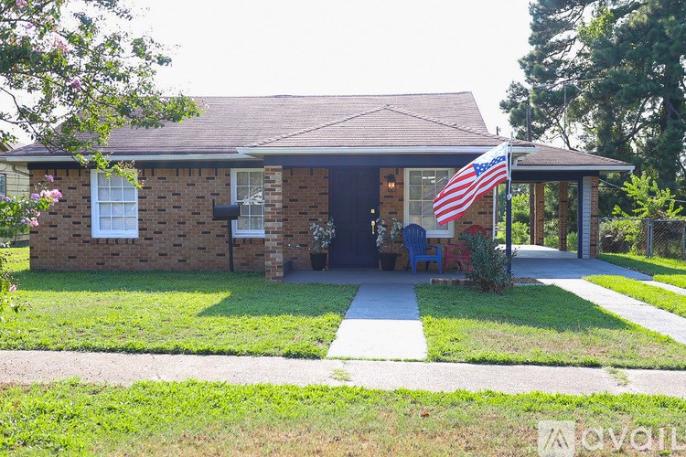 A house with a flag on the front porch.