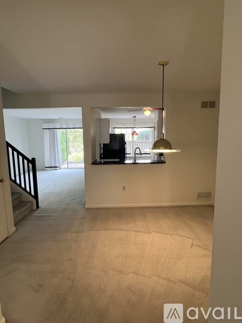 A living room with a television and a bar area.