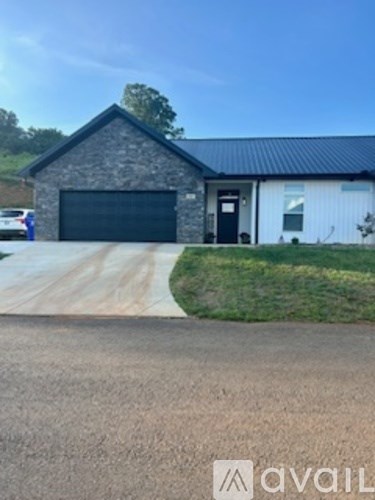 A house with a garage is for sale.