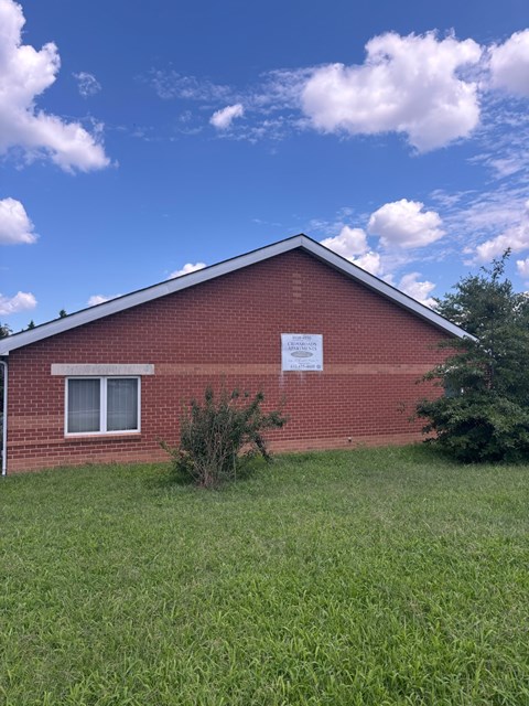 A red brick building with a white sign on it.