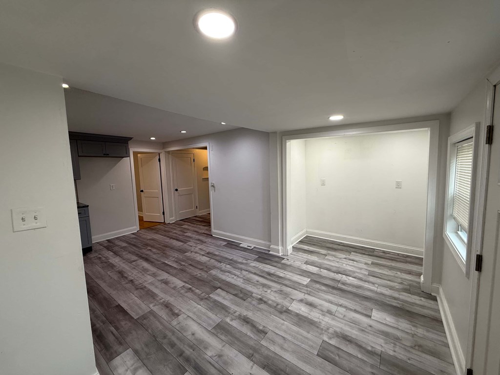 A room with a grey floor and white walls.