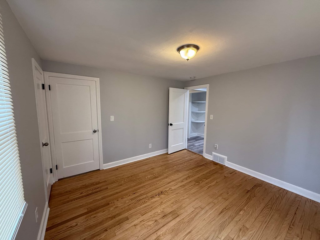 A room with wooden floors and white walls.