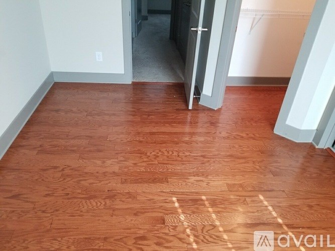 A room with a wooden floor and a doorway.