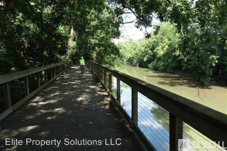 A bridge over a river with a person walking on it.
