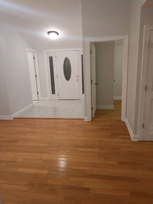 A room with wooden floors and white walls.
