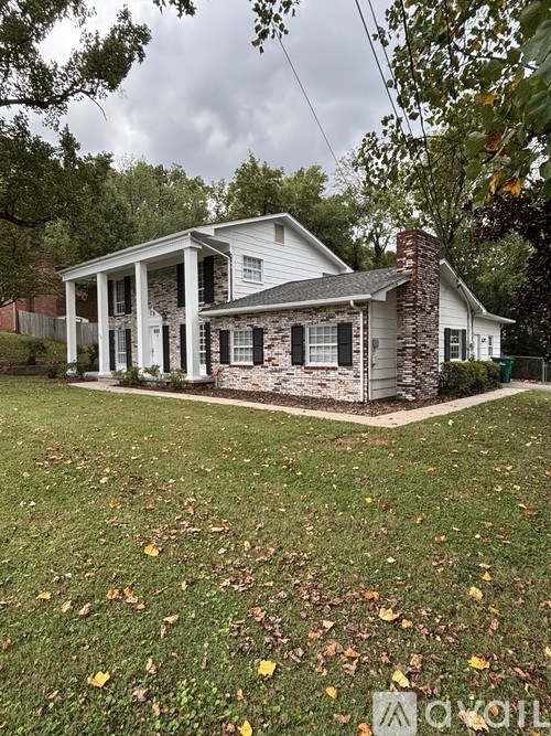 A house with a white front porch and a chimney.