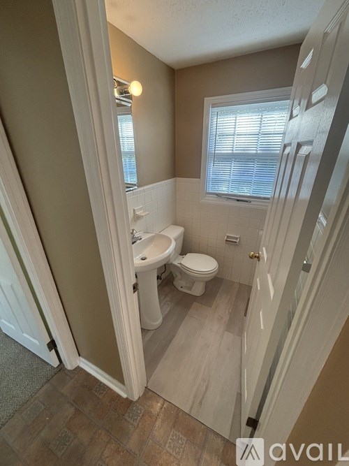 A bathroom with a toilet and sink.