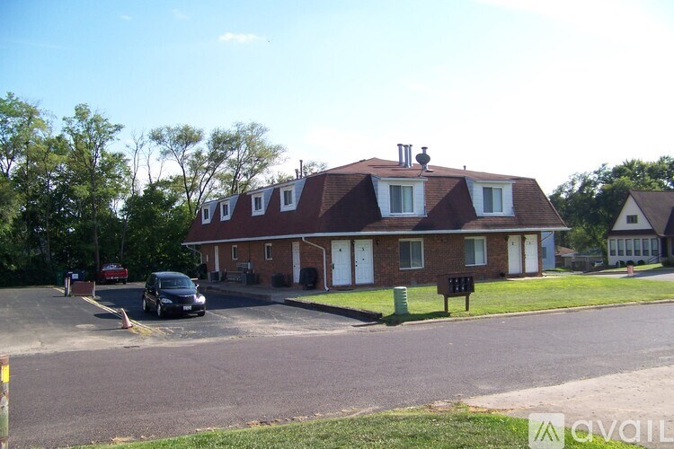 A house with a red car parked in front.