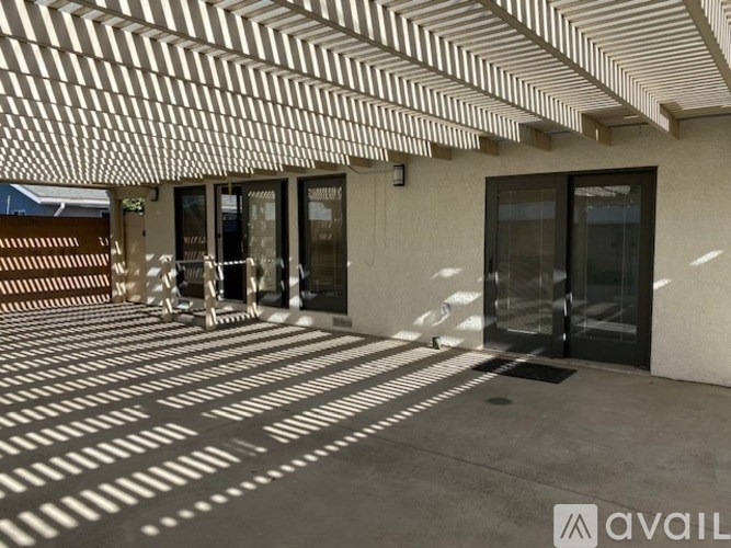 A building entrance with a white striped awning.