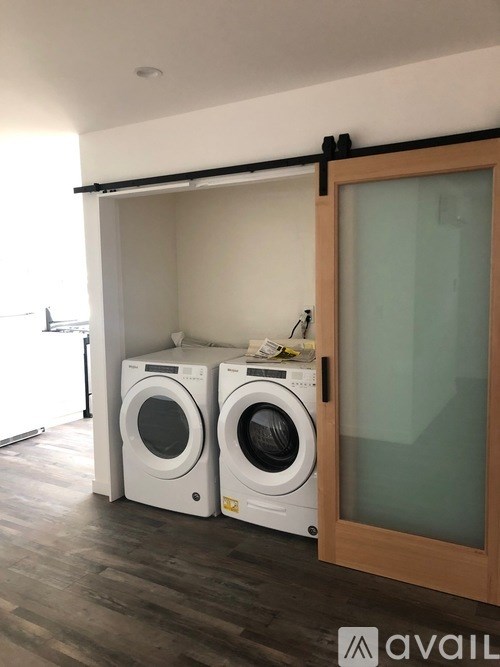 Two washing machines are in a laundry room.