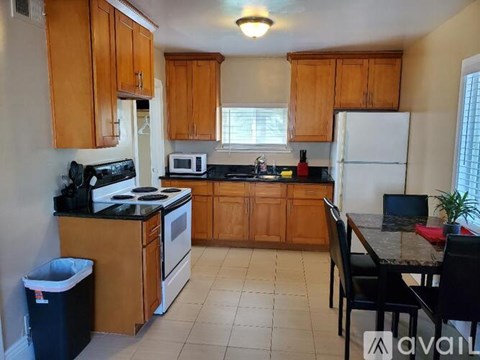 A kitchen with wooden cabinets and a black stove top.