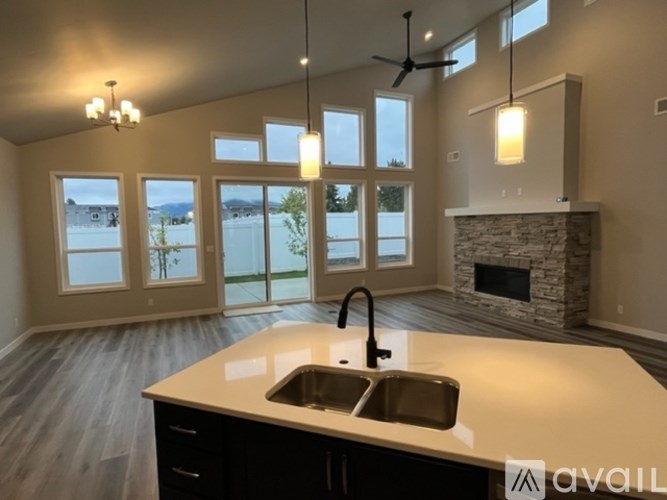 A modern kitchen with a large island and a fireplace.