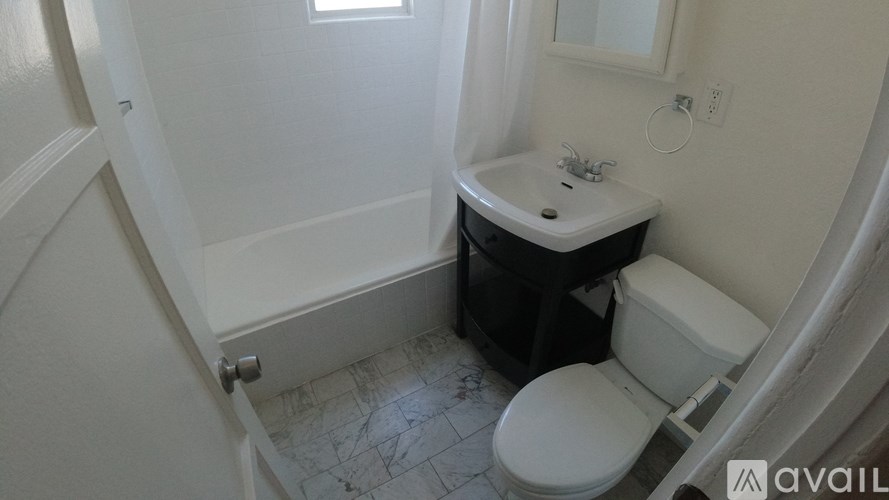A small bathroom with a toilet, sink, and bathtub.
