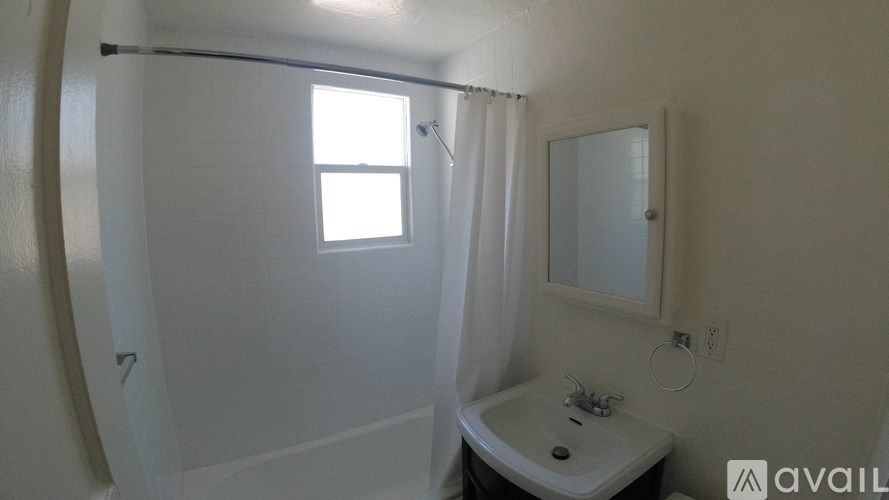 A bathroom with a white tub and sink.
