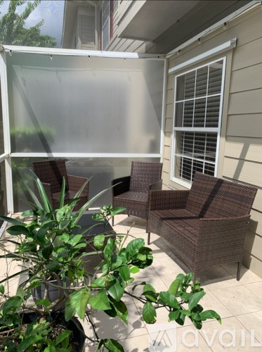 A patio with a chair and a table.