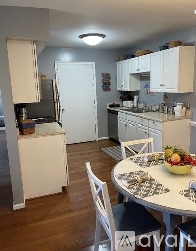 A kitchen with a table and chairs in the middle of the room.
