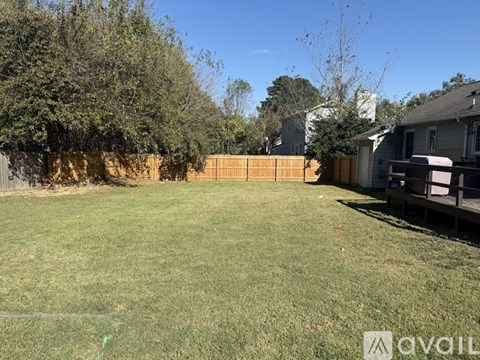 A living room with a fireplace and a fan.
