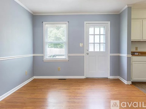 A room with a white door and a window with blinds.