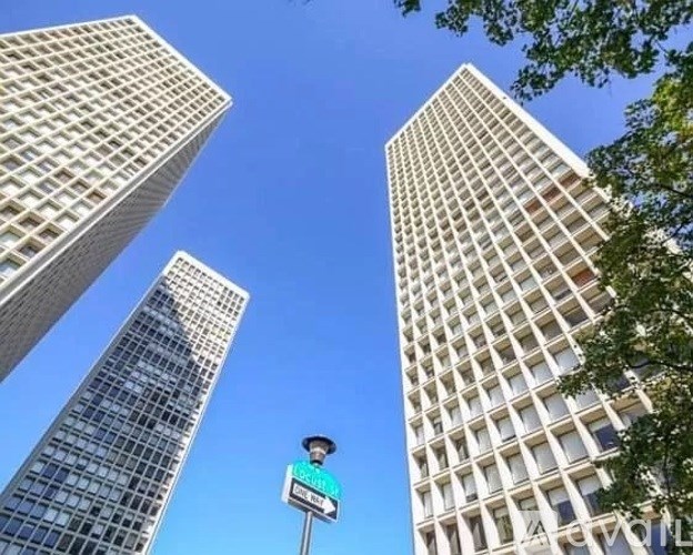Two tall buildings and a street light in the foreground.