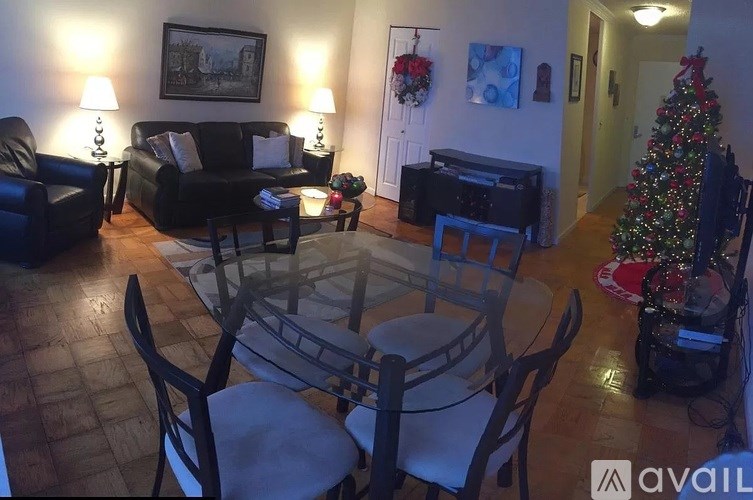 A living room with a Christmas tree and a piano.