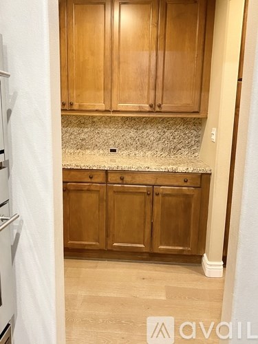 A kitchen with wooden cabinets and a granite countertop.