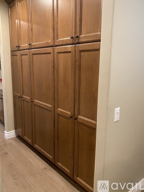 A set of wooden doors in a hallway.