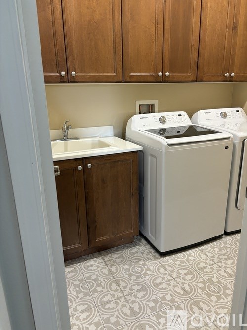 A white washer and dryer in a laundry room.