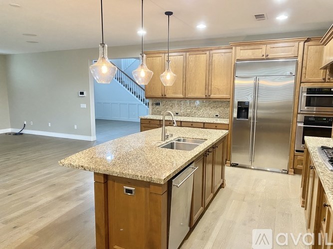 A kitchen with wooden cabinets and granite countertops.
