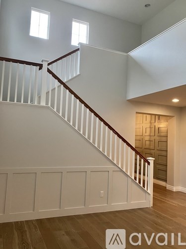 A staircase with white railings and wooden steps.