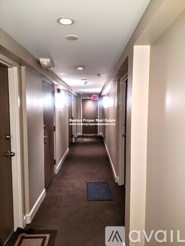 A hallway with a sign that says "Beston Proper Real Estate" on the wall.