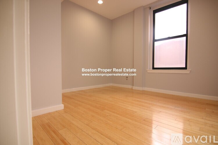 A room with wooden flooring and a window is available for rent.