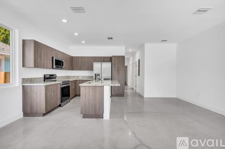 A modern kitchen with a large island in the middle.