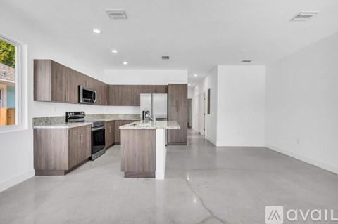 A modern kitchen with a large island in the middle.