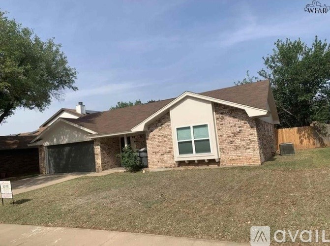 A house with a brown roof and a garage door is for sale.