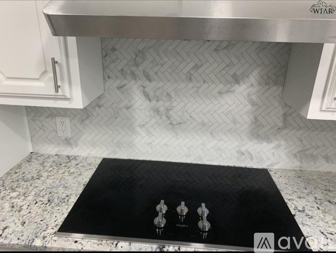 A kitchen with a black mat on the counter.
