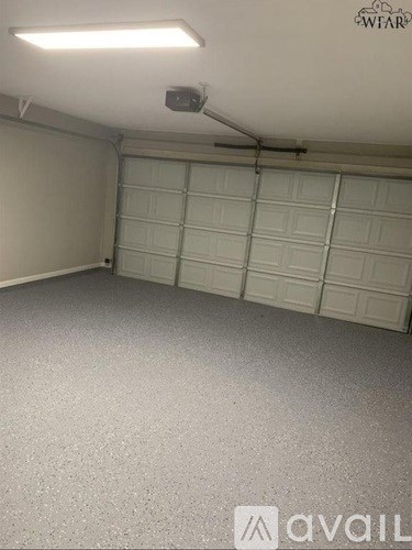 A spacious garage with a closed white door.
